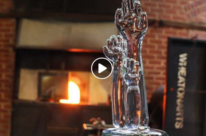 Video of the turnout trophy, three glass hands raised in participation.