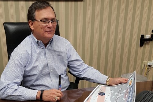 Bill Cowles holding an oversized Adopt-a-Precinct check.