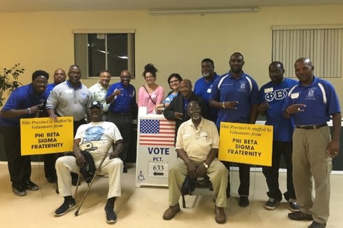 Phi Beta Sigma members at an adopted polling place