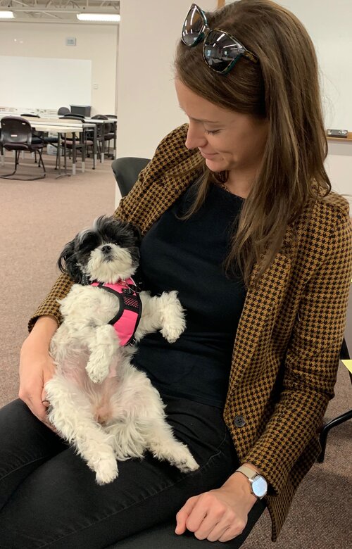 Clerk Molly Fitzpatrick with the cute dog on her lap.