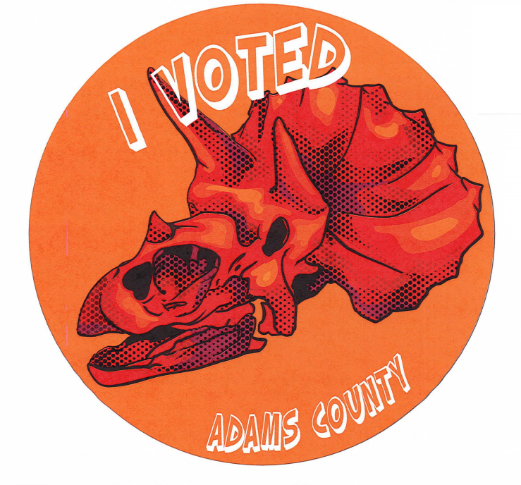 An "I Voted" sticker with a dinosaur