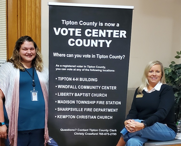 Two women pose next to a sign that says "Tipton County is now a Vote Center County"