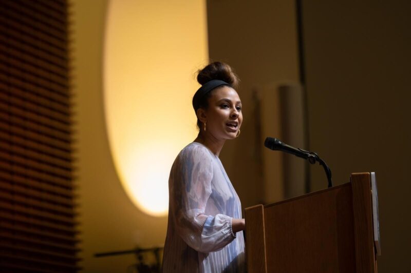 a woman speaks at a podium