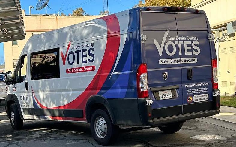 a van with a red, white, and blue design that says "San Benito County Votes"